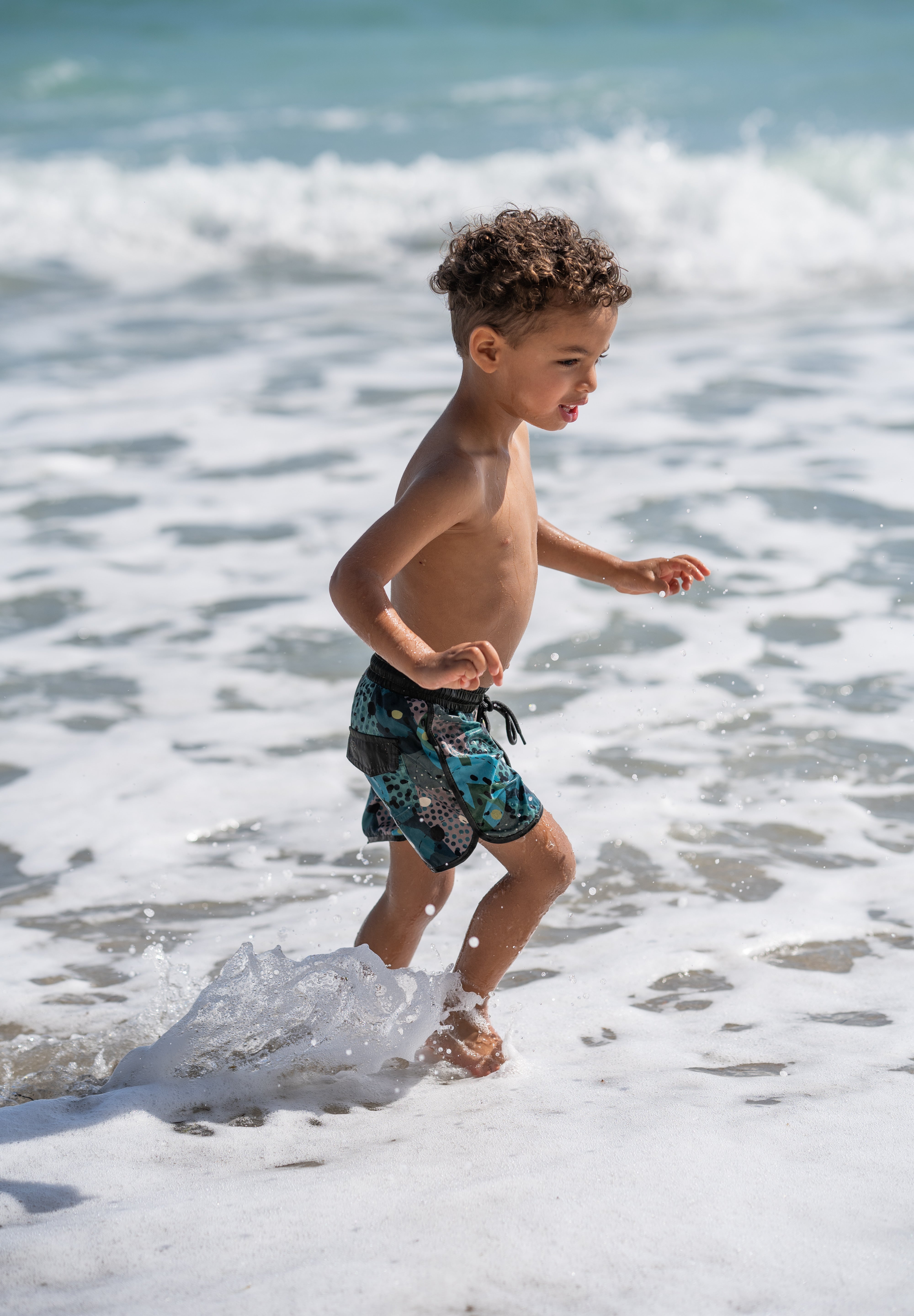 green short Miami Beach fun times kid in the water 