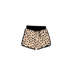 Beige shorts with black dot pattern on a white background