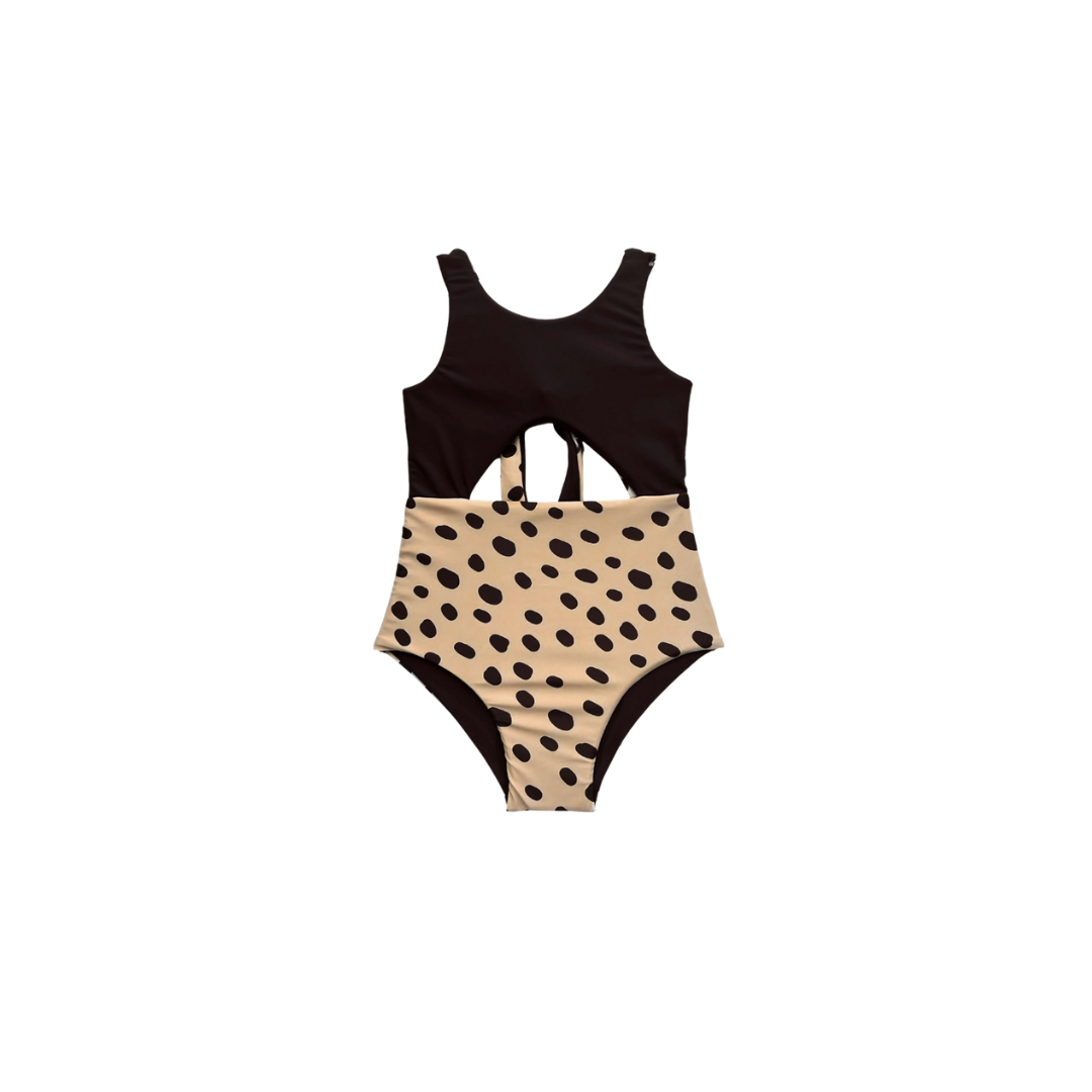 Black and beige swimsuit with polka dot pattern on a white background