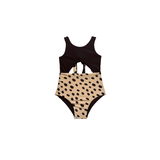 Black and beige swimsuit with polka dot pattern on a white background