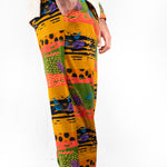 A model wearing a two-piece men's loungewear set with a bold, multicolored abstract print. organic cotton 