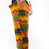 A model wearing a two-piece men's loungewear set with a bold, multicolored abstract print. organic cotton 