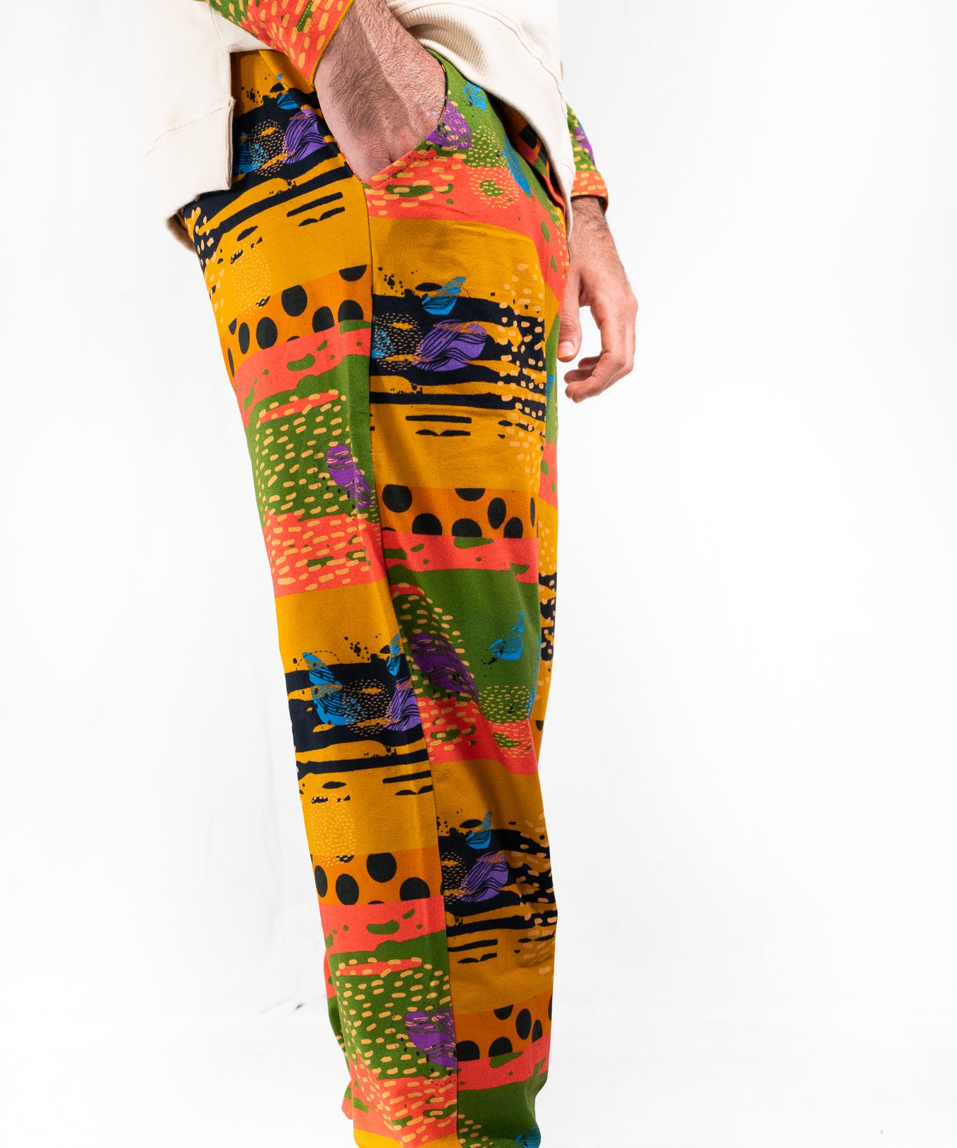 A model wearing a two-piece men's loungewear set with a bold, multicolored abstract print. organic cotton 